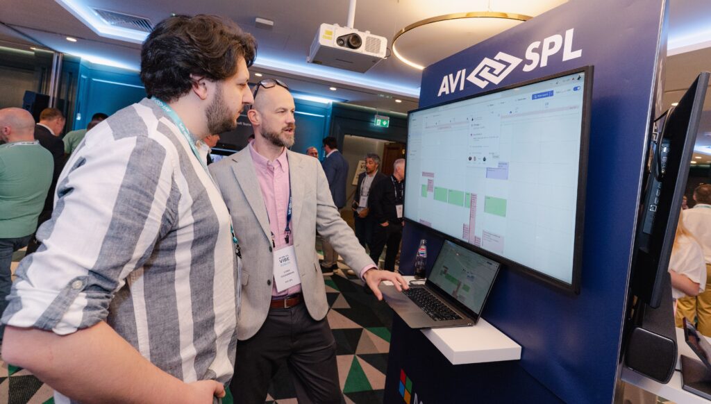 AVI-SPL team member talking to customer in our tech expo at a customer event